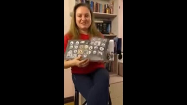 uśmiechnięta bibliotekarka pokazuje omawianą książkę