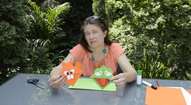 bibliotekarka pokazuje zakładki do książek w kształcie głów zwierząt