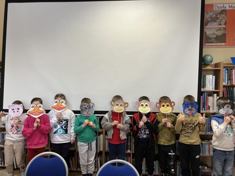 dzieci pozują do zdjęcia ze swoimi pracami plastycznymi - maskami karnawałowymi