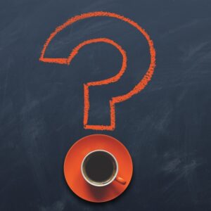 znak zapytania, na dole filiżanka kawy na spodku