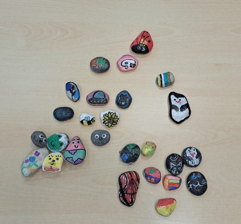 kolorowe kamyki pomalowane podczas warsztatów dla dzieci w bibliotece