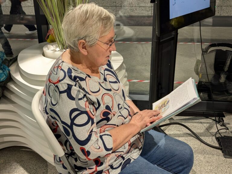 wolontariuszka czyta dzieciom książkę