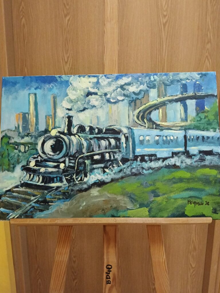 obrazki pociągów zdobiące ścianę biblioteki