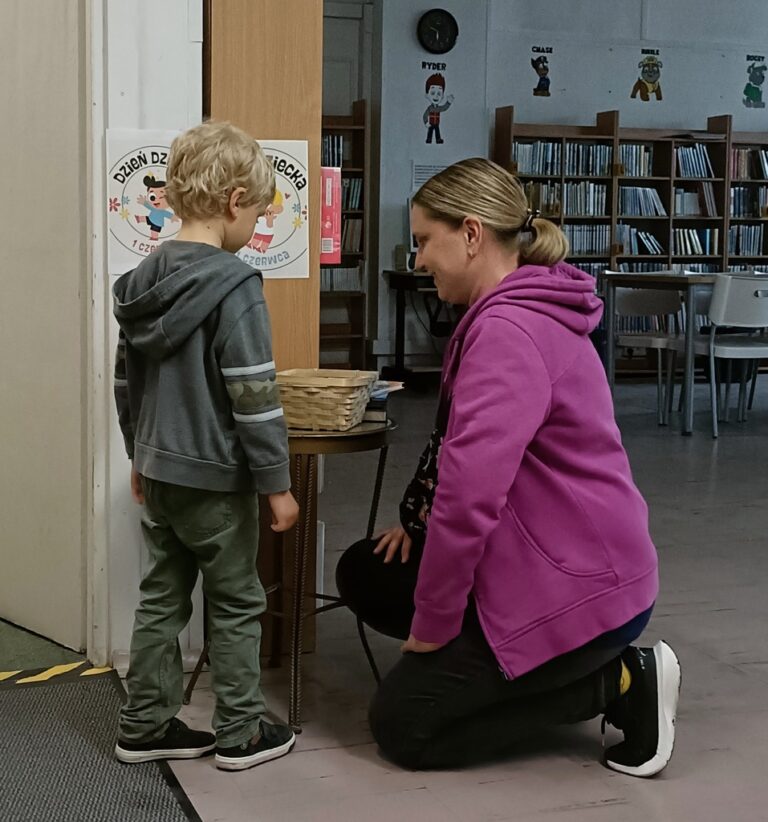 dzieci w bibliotece biorą udział w zabawie z nagrodami; odpowiadają na pytania dotyczące książek